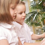 Brother and Sister Playing the Piano Together